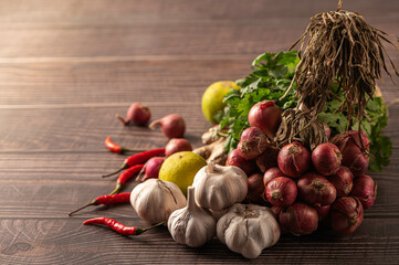  Fresh garlic and spices on wooden background