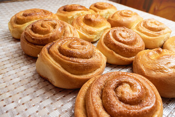 Obraz na płótnie Canvas fresh buns are on the table. side view. fresh baking concept. 