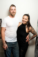 Portrait of a hip couple with tattoos.