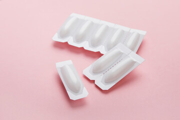 vaginal suppositories on pink background, treatment of vaginal infections from candidiasis, thrush, sexually transmitted infections. Woman health. Contraception, birth control. Planning pregnancy