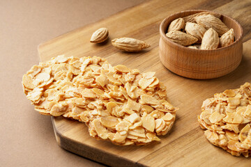 Cookies made of almond petals. Cookies and almonds on the board