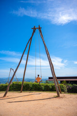 Fototapeta premium Male on swing in the mountains. Asian People relax on swing with the mountain view, Khao Kho, Phetchabun, Thailand.