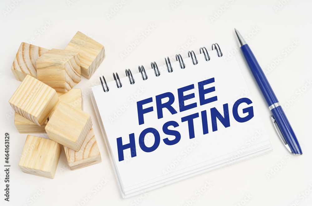 Poster On the table are cubes, a pen and a notebook with the inscription - free hosting