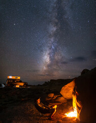 Van Life Camper Cooking Over Campfire Below Night Sky Stars and Milky Way 