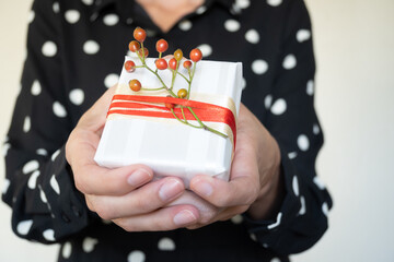 Unrecognizable woman offering handmade Christmas gifts