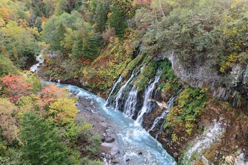 Fototapeta na wymiar A picturesque view of Japan 日本の美しい風景 : Shirohigeno-taki Waterfall in Biei in Hokkaido 北海道の美瑛にある白髭の滝