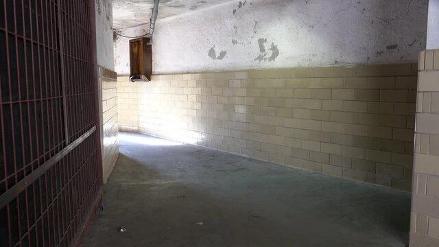 Hallway with institutional tile on death row at Eastern State Penitentiary.