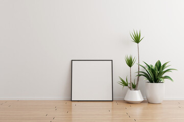 Obraz na płótnie Canvas Black square photo frame mockup on white wall empty room with plants on a wooden floor