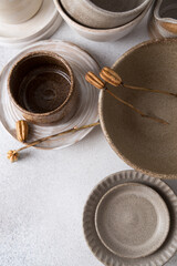 Set of ceramic tableware. Empty craft ceramic plates, bowls, and cups.