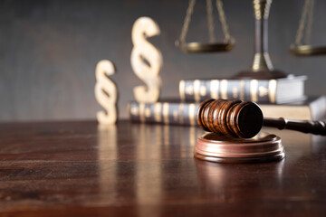 Lawyer office. Law symbols composition: judge’s gavel, Themis sculpture, paragraph sign and scale. © zolnierek