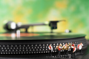 Miniature brass band, turntable and yellow green background
