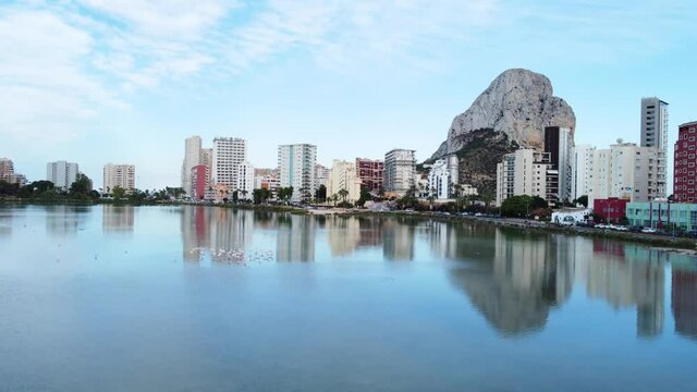 Aerial capture in lake boom elevation motion in the lake's first field and in the background the Penyal d'Ifac Natural Park, Calp, Alicante, Spain.