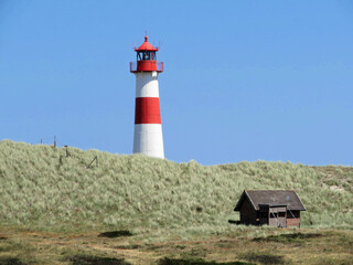 Fototapeta na wymiar Lighthouse in dune on German island Sylt List-Ost