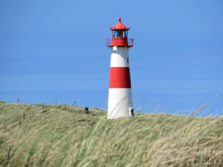 Fototapeta na wymiar Lighthouse in dune on German island Sylt List-Ost