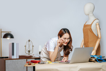 Young female designer use laptop computer searching Idea