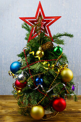 Small decorated Christmas tree on a table in a room