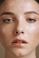 Close up portrait of young with perfect shining skin and freckles