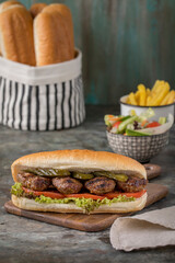 meatball sandwich and 
fried potatoes on the 
wood plate 