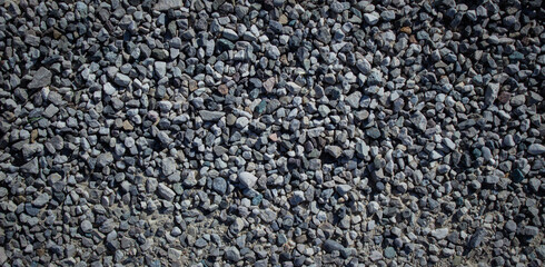The small gray stones of the pattern pebbles as a background. Panoramic photo