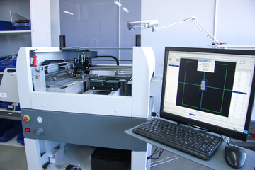 Russia, Moscow, March 27, 2014: Factory for the electronic production. Technological process of soldering and assembly chip components on pcb board. Automated soldering machine