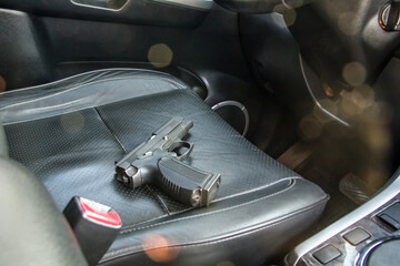 The gun is on the car seat. Criminal situation of the city district