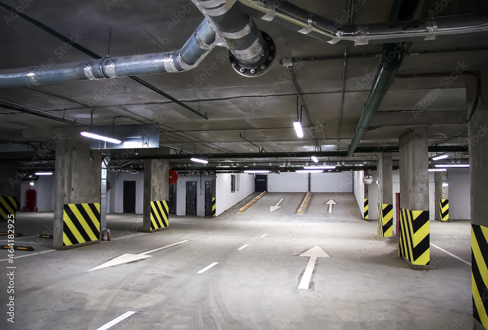 Wall mural Empty parking place in a residential building. Covered underground parking for cars