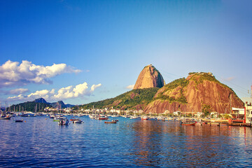 Berth, port with boats, shallops and Urku mountains and Sugar Loaf. Guanabara Bay, a creek on the shores of the Atlantic Ocean. Brasilia, Rio de Janeiro - obrazy, fototapety, plakaty