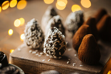Closeup on handmade organic chocolates with coconut chips and cocoa