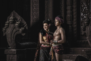 Young Actor and Actress wearing beautiful ancient costumes, in ancient monuments, dramatic style....