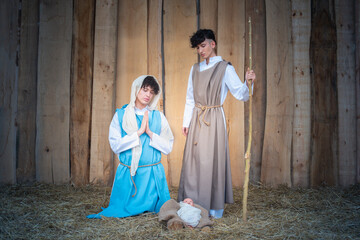 Nativity scene with androgynous people representing the virgin and joseph
