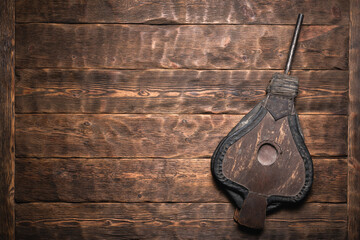 Blacksmith bellows on the wooden flat lay workbench background.