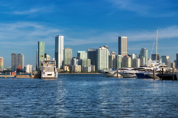 Fototapeta na wymiar Luxury yachts moored in the harbor and Miami Downtown skyline at sunny morning, Miami, Florida.