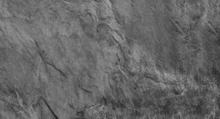 Abstract dark grey black slate background or texture. Close-up. Light gray rock backdrop.
