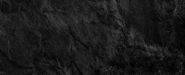 Naklejka premium Panorama dark gray stone background with copy space. Black grunge banner with rock texture.