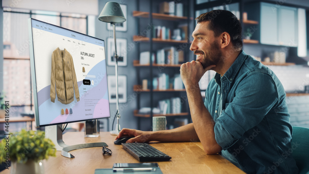 Poster handsome caucasian specialist using desktop computer with clothing online web store to choose and bu