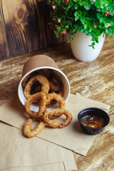 Close-up of onion rings in batter. Fried vegetables at a fast food restaurant. Vegetarian cuisine in a cafe. Meal for those who do not eat meat