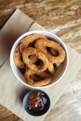 Close-up of onion rings in batter. Fried vegetables at a fast food restaurant. Vegetarian cuisine in a cafe. Meal for those who do not eat meat