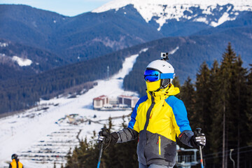 Fototapeta na wymiar woman in ski equipment on the top of the hill