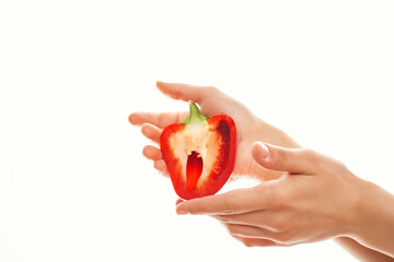 red bell pepper in hands kitchen cooking light background