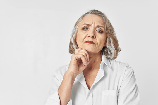 Elderly Woman In White Shirt Emotions Light Background