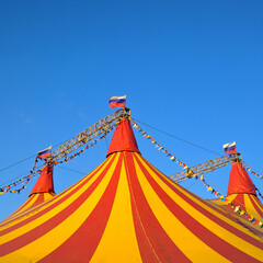 Circus domes with Russian flags in sunny summer weather