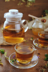 Hot herbal tea with chamomile and honey on wooden background 