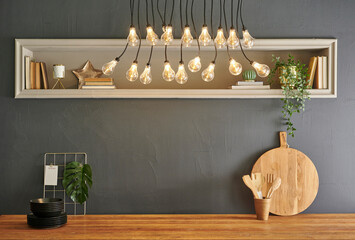 Wooden table, kitchen utensil, wooden cutting board, fork, knife, spoon and stone wall background.