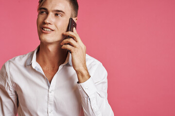 portrait of a man with a phone in hand fashion posing studio lifestyle