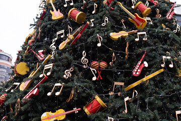 Musical christmas background with guitar , drums , bells on the christmas tree
