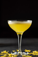 Luxury cocktail with lemon and tequila on a dark stone background