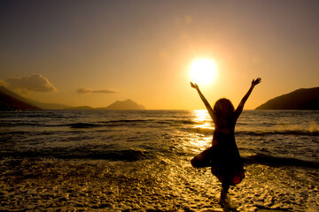 Person doing Yoga on a beach