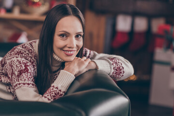 Photo of lovely funky young lady sit rest on couch wear ugly sweater new year at home