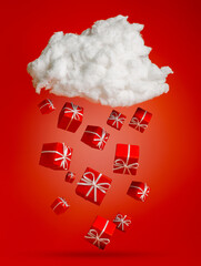 Red Christmas present gifts falling and snowing from the white cloud on vibrant red background. Creative Xmas or New Year seasonal concept. Surreal festive gifting or surprise idea.