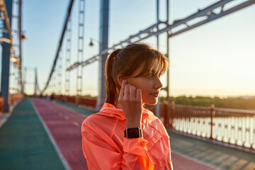 Millennial woman do sports train outdoors in headphones